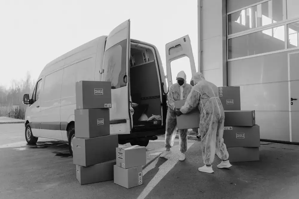 Professional movers loading securely boxed items into a transport truck